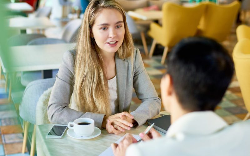 two-business-women-meeting-at-cafe-table